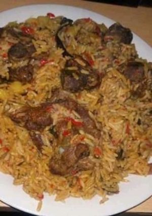 A picture of Jallof rice with Irish and meat.