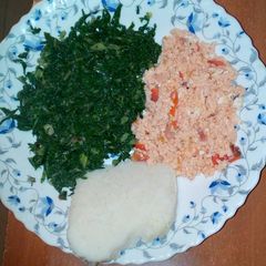 A picture of Fried eggs, served with spinach and ugali.