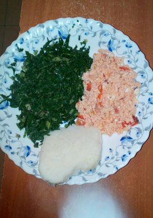 A picture of Fried eggs, served with spinach and ugali.