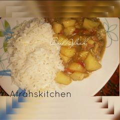 A picture of White rice with potatoes soup.