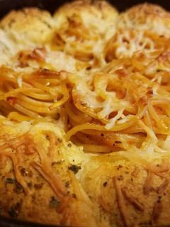 A picture of Italian Garlic Bread Bombs With Toasted Spaghetti.
