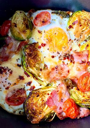 A picture of Baked egg bacon brussel breakfast.