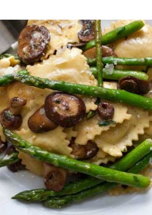 A picture of Ravioli with asparagus and mushrooms.