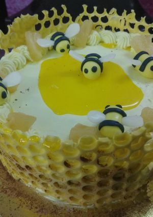 A picture of Honeycomb pineapple cake with bees.