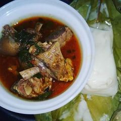 A picture of Grilled Goat Meat Pepper Soup paired with Agidi.