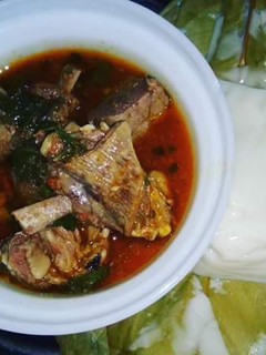 A picture of Grilled Goat Meat Pepper Soup paired with Agidi.