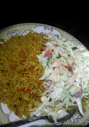 A picture of Jollof rice and colslow.