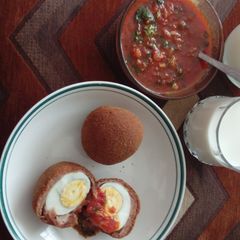 A picture of Scotch eggs with garlic sauce.