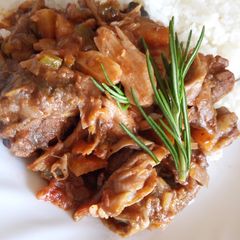 A picture of Beef and mushroom stroganoff served with white rice.