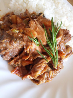 A picture of Beef and mushroom stroganoff served with white rice.