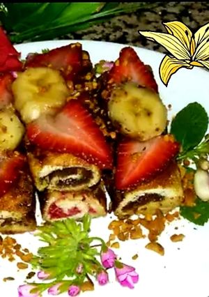 Une photo de Pain de mie roulé au nutella,fraises,banane