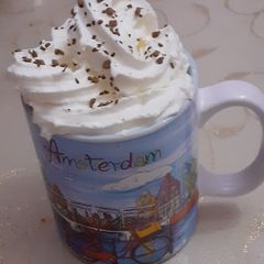 A picture of Milk coffee with whipping cream.