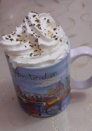 A picture of Milk coffee with whipping cream.