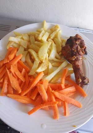 A picture of Grilled Chicken, Chips with Sliced Carrots.