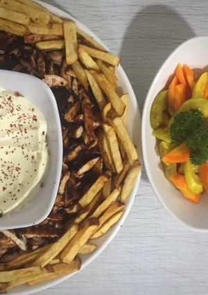 A picture of Home made chicken shawarma with garlic sauce.