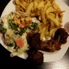 A picture of Chips, salad and grilled chicken.