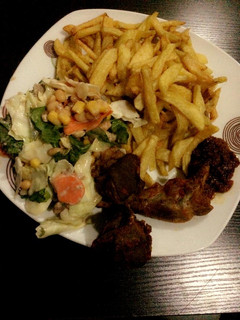A picture of Chips, salad and grilled chicken.
