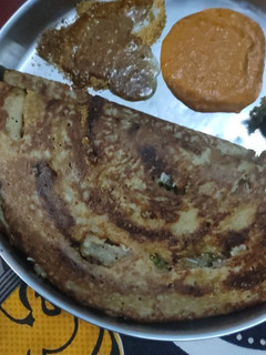 A picture of Palak puree moong dal dosa, sambar/tomato chutney.