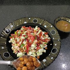 A picture of Kala chana salad with tangi sauce.