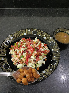 A picture of Kala chana salad with tangi sauce.