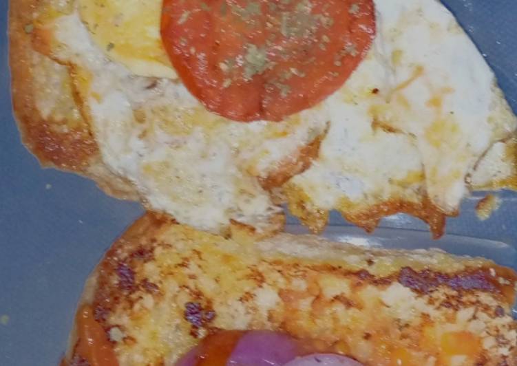 Bun-egg toast topped with sauted onions and tomatoes