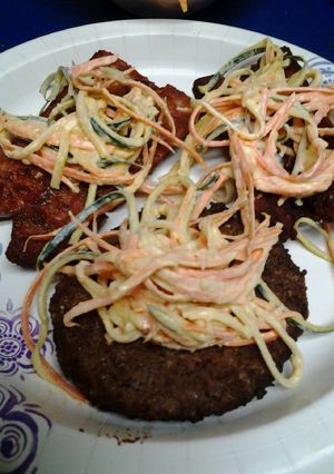 A picture of Slaw on sausage and a burger.