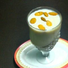 A picture of Banana shake with ice cream and dry fruits.