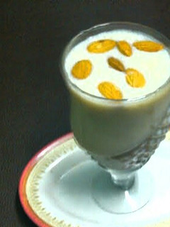 A picture of Banana shake with ice cream and dry fruits.