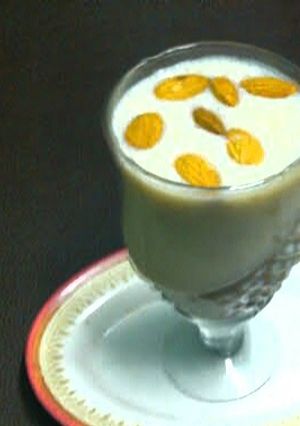 A picture of Banana shake with ice cream and dry fruits.