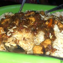 A picture of White rice with chicken breast stew.