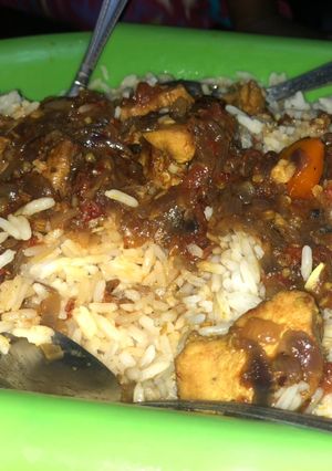 A picture of White rice with chicken breast stew.