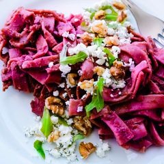 A picture of Pasta with a spicy beetroot sauce, feta, dill and walnuts.