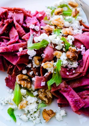 A picture of Pasta with a spicy beetroot sauce, feta, dill and walnuts.