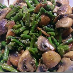 A picture of Sauteed mushrooms and asparagus.