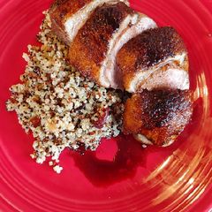 A picture of Duck Breast with cranberry walnut quinoa and balsamic reduction.