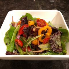 A picture of Green salad with homemade spicy balsamic vinegar.