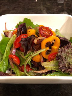 A picture of Green salad with homemade spicy balsamic vinegar.