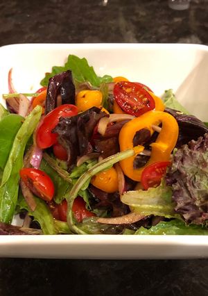 A picture of Green salad with homemade spicy balsamic vinegar.