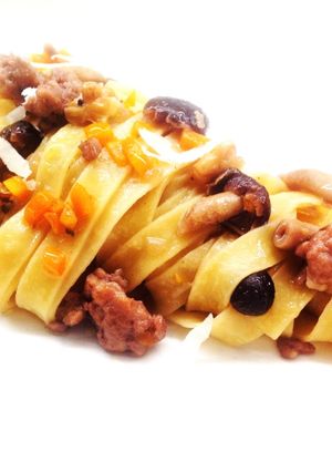 A picture of Tagliatelle with Salamella Ragù, Pioppini Mushrooms, and Walnuts.