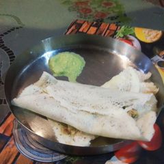 A picture of Special Paneer Dosa with chutney.