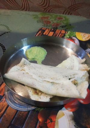 A picture of Special Paneer Dosa with chutney.
