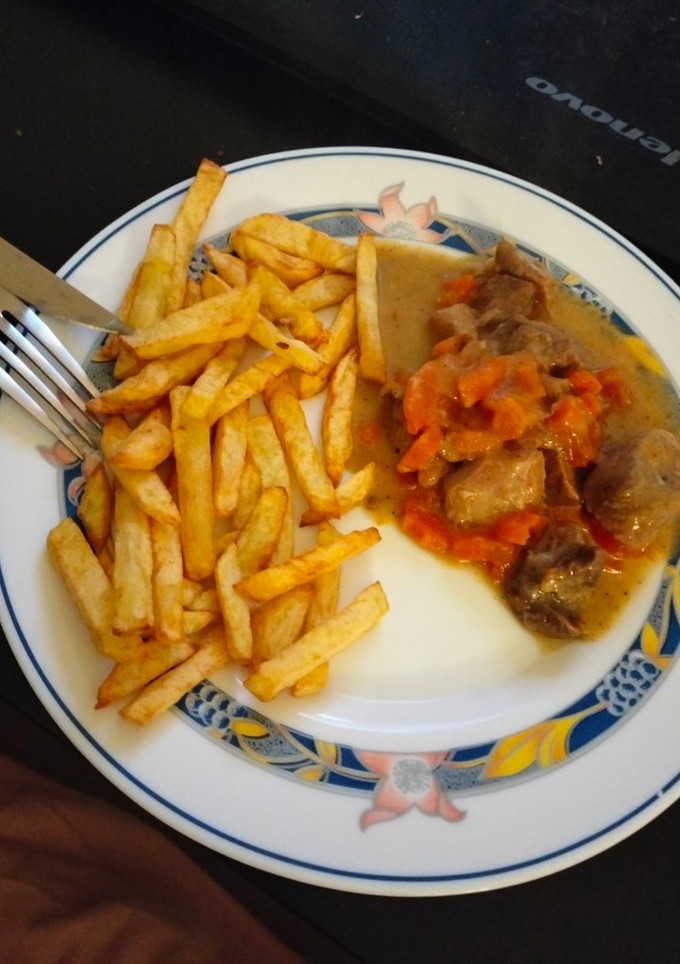 Una foto de Carne en salsa acompañada de patatas fritas