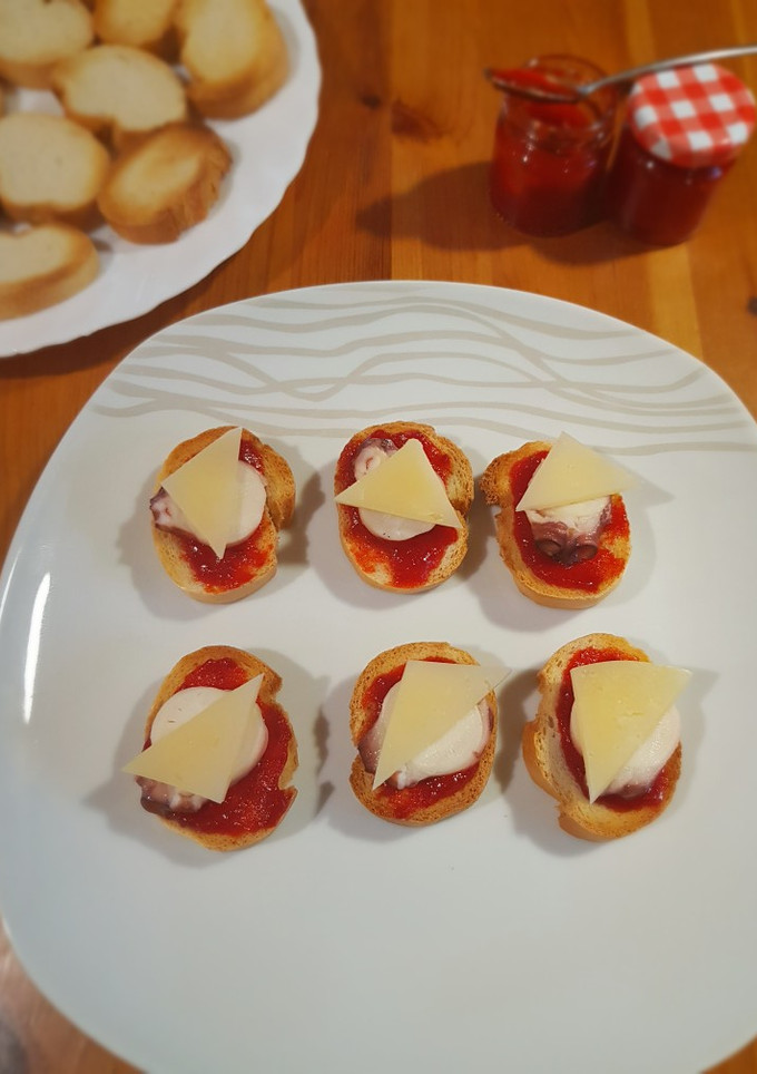 Una foto de Canapé de pulpo, pimiento confitado y queso manchego