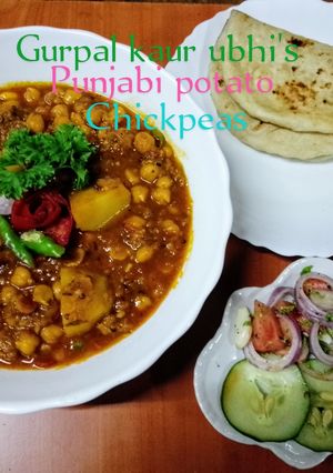 A picture of Punjabi potato chickpeas 🥔🍅🌿🧅🧄.