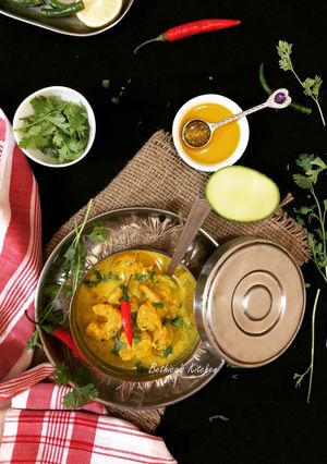 A picture of Aam Shorshe Chingri Bhapa (Steamed Mango-Mustard Prawn Curry - Bong style).