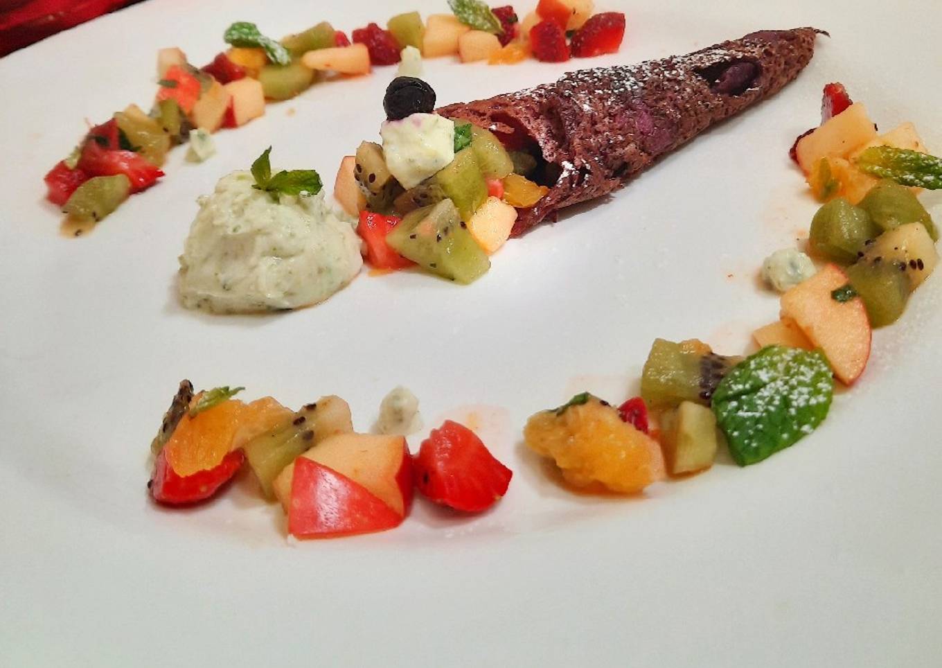 Fruity rava dosa served with fruit chat and pistachio shrikhand