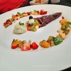 A picture of Fruity rava dosa served with fruit chat and pistachio shrikhand.