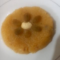 A picture of Besan halwa with fresh cream.