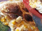 Una foto de tarta de choclo en granos y queso