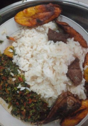 A picture of White rice, vegetable, plantain and fried beef.
